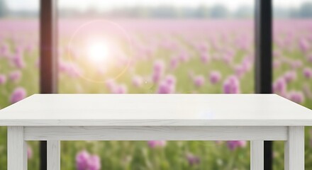 Fototapeta premium White wooden table with blurred pink flower field background in the window