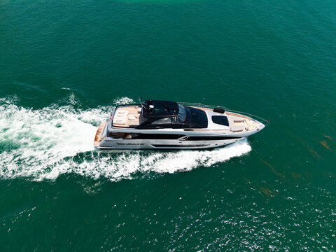 Summer sea vacation. Boat trip. Luxury lifestyle and traveling. Sea boat go to yacht marina. Yachting and boating marina. Yacht boat sailing. Top view. Aerial view luxury motorboat in sea