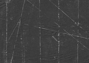 Crumpled black paper texture with fold lines. Creased and distressed surface background. Suitable for overlay design, poster, cover, or banner.