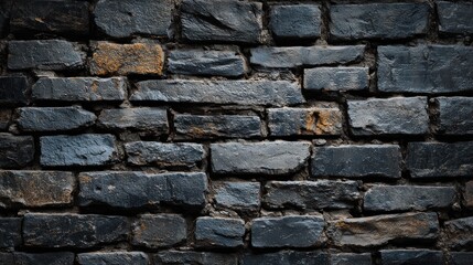 Naklejka premium A textured wall made of dark bricks, showcasing a mix of rough surfaces and subtle color variations.