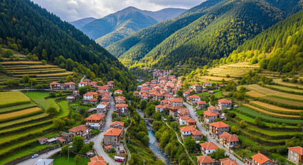 Aerial view of the picturesque village of kosovo in the rhodope mountains, bulgaria, showcasing traditional houses, terraced fields, and stunning mountain scenery