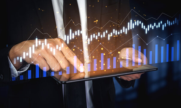 Business professional interacts with a digital tablet, analyzing financial data through modern graphs and charts to enhance decision-making in a corporate setting. Scalp