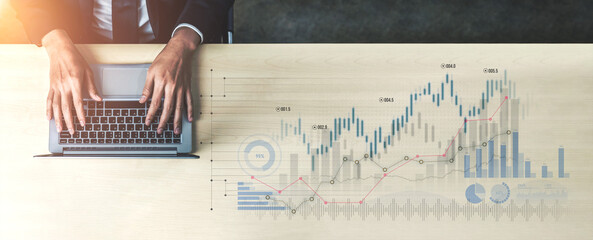 A business professional analyzing financial data on a laptop at a modern workspace. Hands actively engage with graphs and charts that visualize key performance metrics. Scalp
