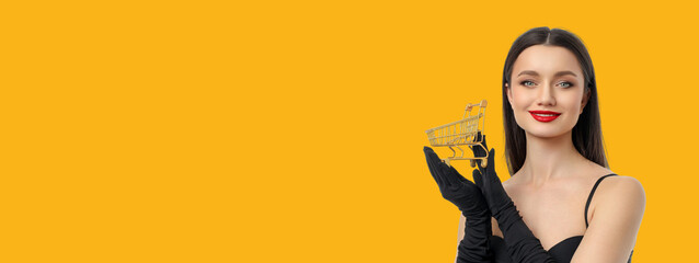 Woman with long hair and red lips holds shopping cart