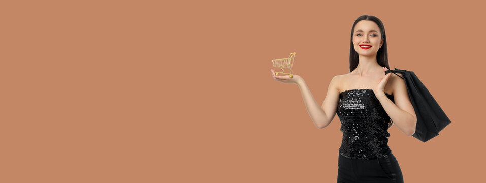 Woman in black sequin dress holding shopping cart and bag