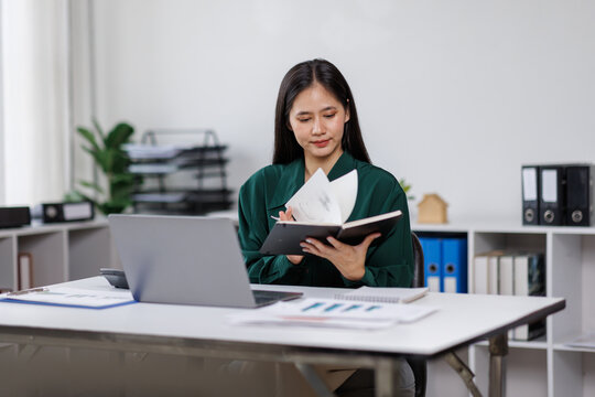 asian woman employee discuss monthly earning graph together in the office
