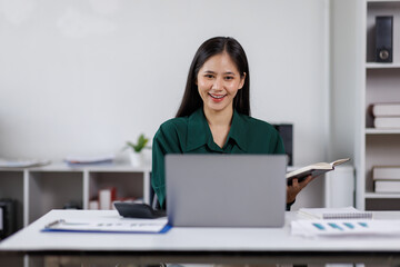 asian woman employee discuss monthly earning graph together in the office
