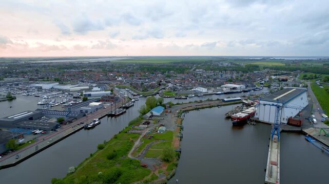 Aerial view of industries, port and marina during sunset in historic Urk fishing town in The Netherlands