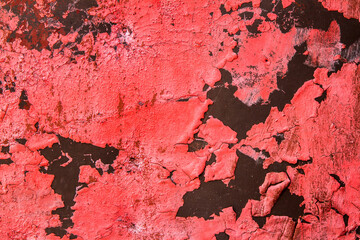 The texture of peeled old red paint. Rich red on a dark base