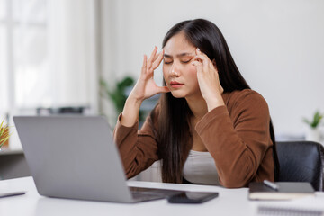 Sad and frustrated asian woman feeling tired and worried about a problem sitting at desk with laptop, stressed and in pain female having problems reading bad news online, email notification about debt