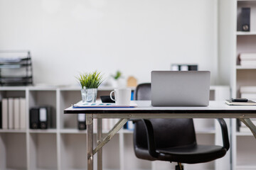 Modern office workplace with laptop computer, coffee cup and office supplies laptop office.
