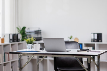 Modern office workplace with laptop computer, coffee cup and office supplies laptop office.
