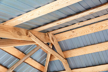 Looking up at the crisscrossed wooden beams that hold up the roof over your head