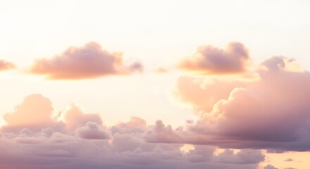 Fototapeta premium Fluffy clouds at sunset soft pastel colors atmospheric background for design projects