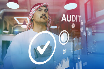 Business professional engaged in audit review with digital data insights in an office setting