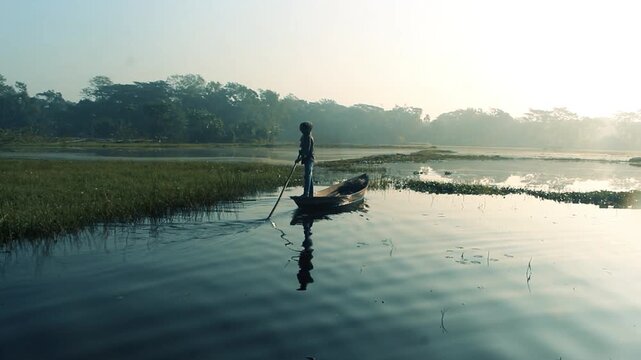  A man in the middle of the lake boat during morning fishing. Fisherman, River, Boat, Paddling . close-up video