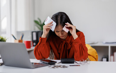 Credit card problem. Worried and stress young woman sitting in living room working and get headache make purchase in online store on laptop

