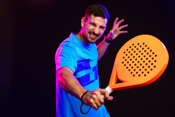 Player showing intense emotion while preparing to hit a ball with a paddle