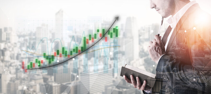 A focused businessman examines stock market trends with digital graphs. The city skyline serves as a backdrop, showcasing modern finance and investment strategies. Impute
