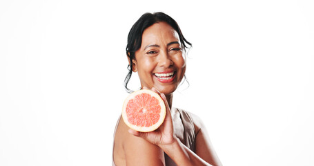 Portrait, skincare and mature woman with grapefruit, mockup space or facial treatment with vitamin c. White background, natural cosmetics and anti aging benefits for person, happy and dermatology