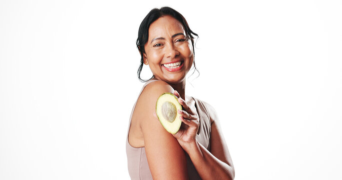 Portrait, skincare and woman with avocado, studio or facial treatment with vitamin c or antioxidants. White background, natural cosmetics and mature person with fruit, anti aging and mockup space