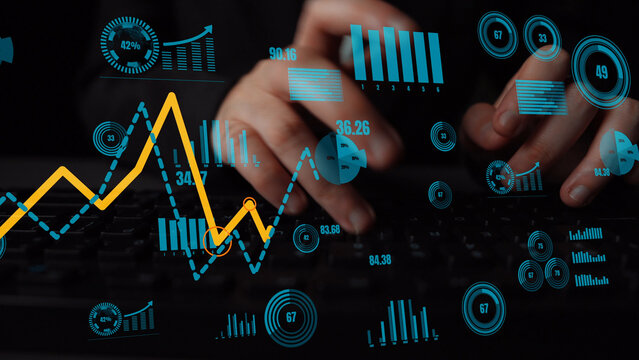 A close-up image of hands typing on a computer keyboard surrounded by vibrant data visualizations, graphs, and metrics that represent digital analysis and business intelligence. Xenic