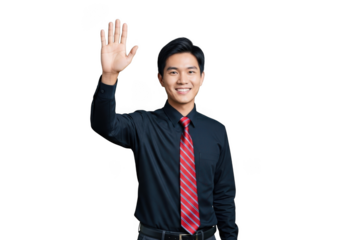 A young asian man in a dark shirt and red striped tie smiles and waves hello with his right hand isolated on transparent background
