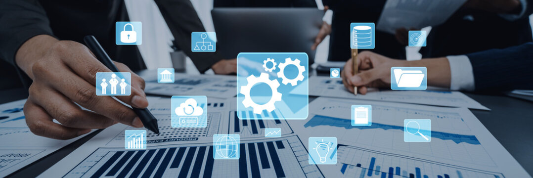 Business professionals engaged in data analysis with digital icons representing technology trends, focusing on enhancing performance and informed decision-making in a modern workspace. Trope