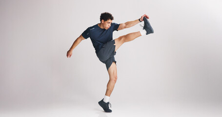 Fitness, kick and stretching with man on studio space for start of training or workout routine....