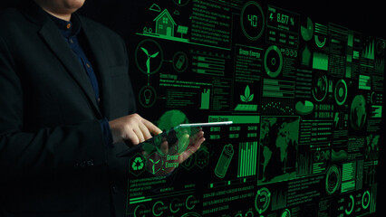 A professional engaged in analyzing green energy data on a tablet, surrounded by visual graphics in a dark setting, showcasing eco-friendly technology and sustainability trends. Cipher