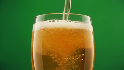 Refreshing golden beer pouring into a clear glass against a vibrant green backdrop creating a dynamic and thirst-quenching visual experience