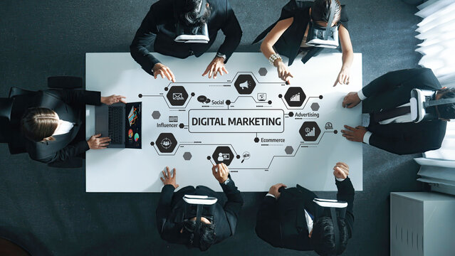 A group of professionals collaborates on a digital marketing strategy using technology and virtual reality, showcasing innovation in business growth and online engagement methods. Amity