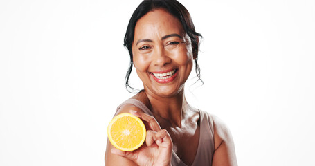 Portrait, skincare and woman with orange, glow and facial treatment with vitamin c and mockup space. White background, natural cosmetics and mature person with fruit, anti aging benefits and studio