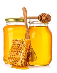 Two glass jars of golden liquid with honeycomb and wooden utensils