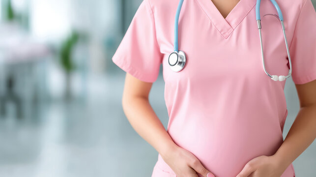 Close-up image of a pregnant medical professional in pink scrubs with a stethoscope, representing maternity, healthcare work, and occupational wellbeing