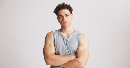 Portrait, man and bodybuilder with arms crossed in studio for fitness, exercise pride or healthy body. Mockup space, person and confidence for training, strong muscles and flexing on white background