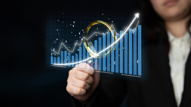 A business professional examines digital growth data, showcasing a positive trend in a financial analysis context. Ideal for themes of success and strategy. Impute - Powered by Adobe