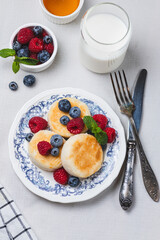 Cheesecakes with powdered sugar and berries on a plate