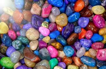 Colorful small stones arranged together forming a vibrant natural texture background