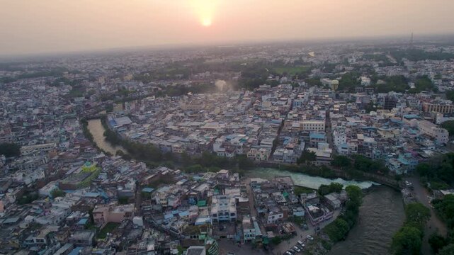 Aerial view of the Cooum River winding through Chennai City, Tamil Nadu. This short but significant river flows toward the Bay of Bengal, showcasing urban landscapes and waterway scenery.