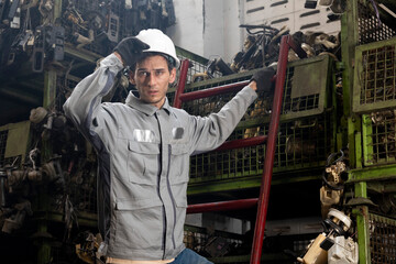 Technician worker working and checking in garage scrap yard car workshop warehouse.