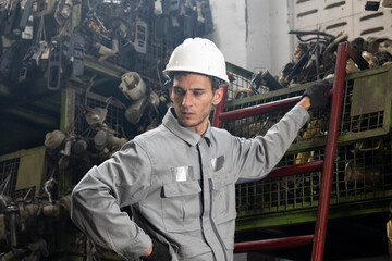 Technician worker working and checking in garage scrap yard car workshop warehouse.
