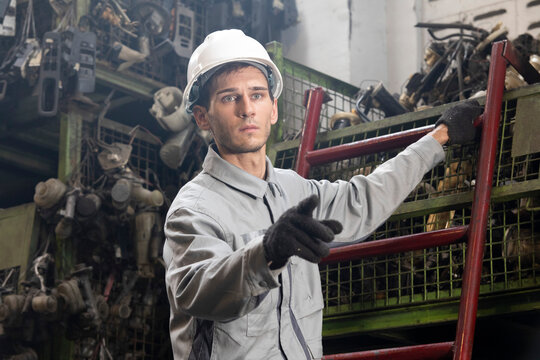 Technician worker working and checking in garage scrap yard car workshop warehouse.