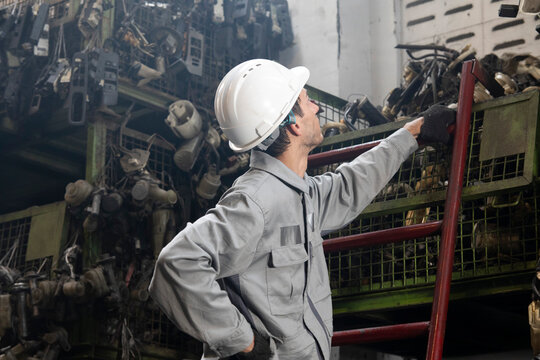 Technician worker working and checking in garage scrap yard car workshop warehouse.