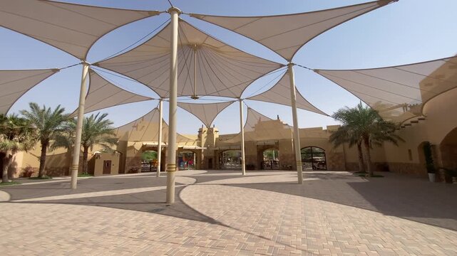 The grand entrance courtyard of Al Ain Zoo features wide walkways, landscaped greenery, and welcoming architectural elements in Abu Dhabi.