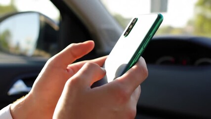 Closeup of a persons hands holding and actively using a modern smartphone inside a car showcasing mobile technology and connectivity on the go. - Powered by Adobe