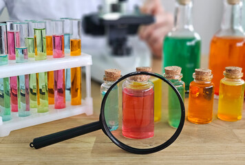 Colorful laboratory setup with glass bottles, test tubes, and microscope in a science experiment scene concept