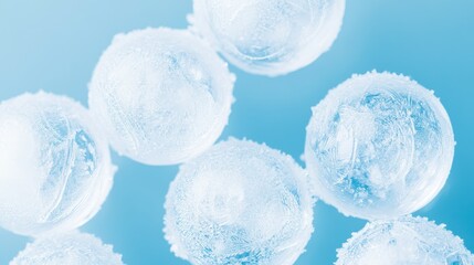 Frosted icy spheres on light blue background. Macro view of frozen water droplets with abstract texture.
