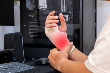Employee with bandaged wrist shows signs of work-related strain or injury. Red inflammation highlights ergonomic risk. Copy space for safety or medical ads.