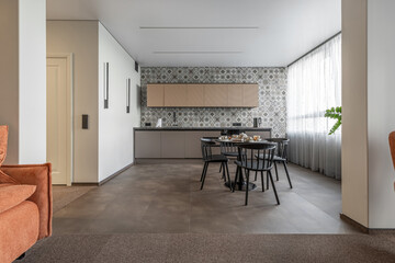 Bright Modern Kitchen with Patterned Wall Tiles and Black Furniture